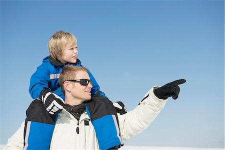 Father carrying son on shoulder, smiling, Bavaria, Germany Stock Photo - Premium Royalty-Free, Code: 6121-07739988