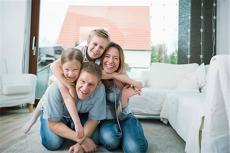 Happy family with two kids at home Stock Photo - Premium Royalty-Free, Code: 6121-07809725