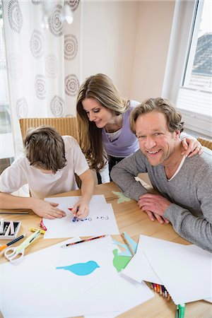 peindre (activité artistique) - Boy drawing a picture with parents at table Photographie de stock - Premium Libres de Droits, Code: 6121-07809881