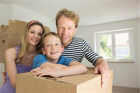 Young family happy new home smiling moving in Stock Photo - Premium Royalty-Free, Code: 6121-07809990