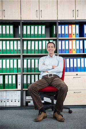Man sitting chair filing cabinet office relaxed Foto de stock - Sin royalties Premium, Código: 6121-07810033