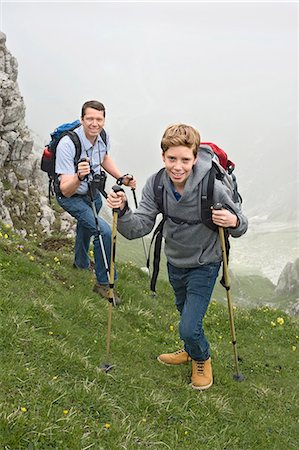 Father and son hiking in mountains Alps Stock Photo - Premium Royalty-Free, Code: 6121-07810254