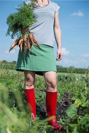 rain boots - Gardening woman holding carrots harvest Stock Photo - Premium Royalty-Free, Code: 6121-07970067
