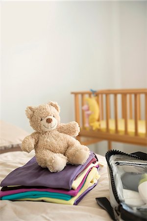 stuffed animal - Baby bedroom cot teddy bear clothes suitcase Stock Photo - Premium Royalty-Free, Code: 6121-07970019