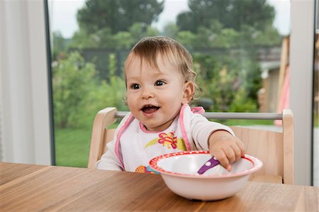 Smiling happy baby girl portrait table bowl Stock Photo - Premium Royalty-Free, Code: 6121-07970162