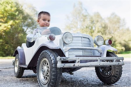 Small boy sitting driving model vintage car Stock Photo - Premium Royalty-Free, Code: 6121-07970118