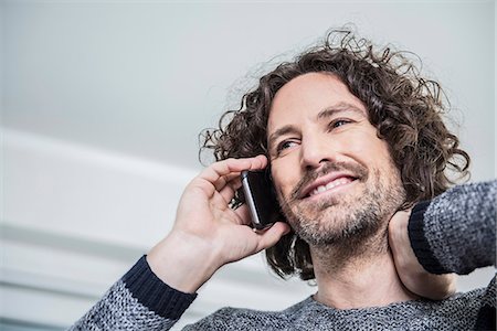 Businessman talking on mobile phone in an office, Munich, Bavaria, Germany Foto de stock - Sin royalties Premium, Código: 6121-07992541
