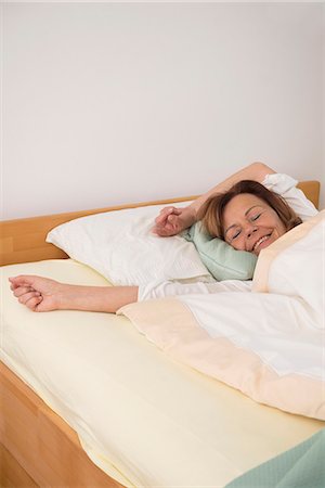 Senior woman sleeping in her bedroom, Munich, Bavaria, Germany Stock Photo - Premium Royalty-Free, Code: 6121-08106564