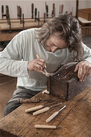 Carpenter restoring an antique bone box at workshop, Bavaria, Germany Stock Photo - Premium Royalty-Free, Code: 6121-08106799