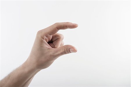 Close-up of man's hand indicating size with fingers, Bavaria, Germany Foto de stock - Sin royalties Premium, Código: 6121-08106885
