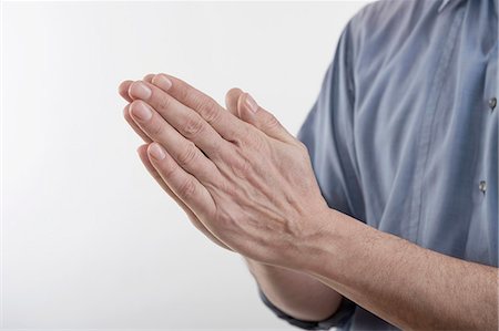 front - Man's clasped hands in prayer position, Bavaria, Germany Stock Photo - Premium Royalty-Free, Code: 6121-08106893
