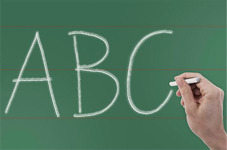 Close up of person's hand writing 'ABC' on chalkboard, Bavaria, Germany Photographie de stock - Premium Libres de Droits, Code: 6121-08106891