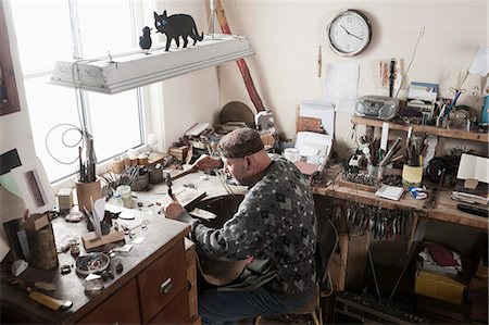 Senior male jeweler hitting punches in workshop, Bavaria, Germany Stock Photo - Premium Royalty-Free, Code: 6121-08106899