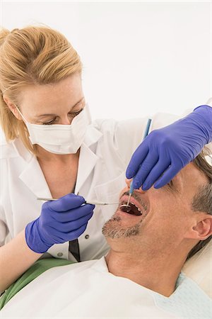 Female dentist examining patient, Munich, Bavaria, Germany Stock Photo - Premium Royalty-Free, Code: 6121-08228456