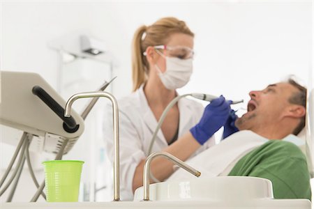 Female dentist examining patient, Munich, Bavaria, Germany Stock Photo - Premium Royalty-Free, Code: 6121-08228458