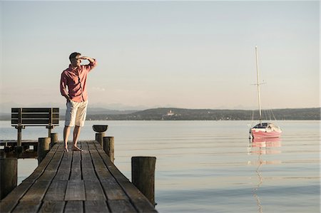 segelmast - Mature man standing on wooden pier and looking at distance, Bavaria, Germany, Stockbilder - Premium RF Lizenzfrei, Bildnummer: 6121-08361563