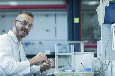 flask - Portrait of a young male scientist working in a pharmacy laboratory, Freiburg im Breisgau, Baden-Württemberg, Germany Stock Photo - Premium Royalty-Free, Code: 6121-08522384
