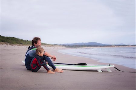 surfing - Father with son looking at view and sitting on beach, Viana do Castelo, Norte Region, Portugal Stock Photo - Premium Royalty-Free, Code: 6121-08522308