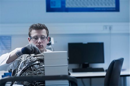Young male scientist working in an optical laboratory, Freiburg Im Breisgau, Baden-Württemberg, Germany Stock Photo - Premium Royalty-Free, Code: 6121-08522448