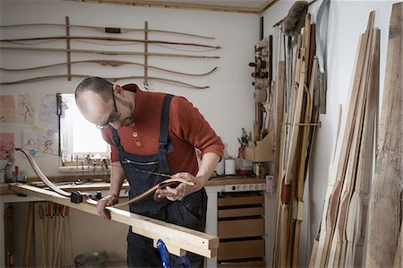 Male bow maker making bow in workshop, Bavaria, Germany Stock Photo - Premium Royalty-Free, Code: 6121-08660286