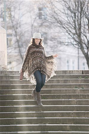 Mature woman moving down on staircases, Bavaria, Germany Stock Photo - Premium Royalty-Free, Code: 6121-08660325