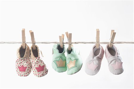 simsearch:6102-07158083,k - Three pairs of baby shoes hanging on clothes line, Bavaria, Germany Photographie de stock - Premium Libres de Droits, Code: 6121-08859062