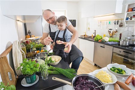 red cabbage - Father and son preparing dumplings in kitchen Stock Photo - Premium Royalty-Free, Code: 6121-09146576