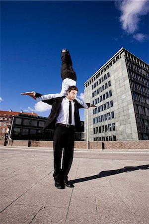 Man with woman on shoulder Stock Photo - Premium Royalty-Free, Code: 6122-07691963