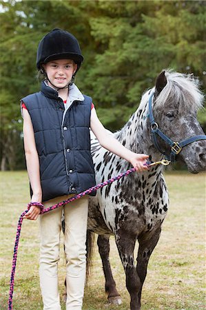 Girl standing with horse Stock Photo - Premium Royalty-Free, Code: 6122-07692693