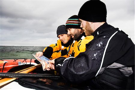 3 men looking at map Stock Photo - Premium Royalty-Free, Code: 6122-07692930