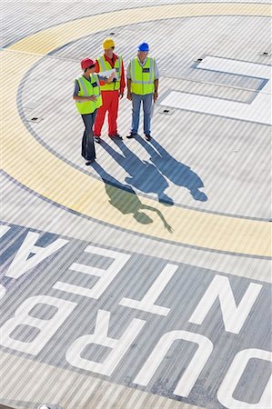 Three workers on helideck Stock Photo - Premium Royalty-Free, Code: 6122-07693049