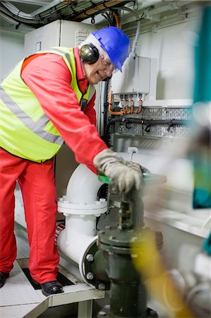 engine room of a ship - Man doing maintenance works Stock Photo - Premium Royalty-Free, Code: 6122-07693068