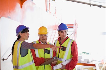 safety worker open arm - Architects and builders at work Stock Photo - Premium Royalty-Free, Code: 6122-07693075