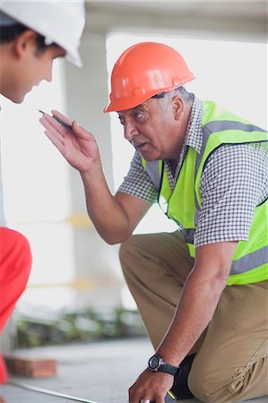 Old worker talking to young worker Stock Photo - Premium Royalty-Free, Code: 6122-07693111