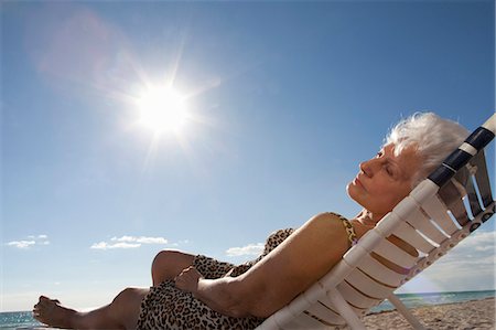 relaxing in lounge chair - Senior Woman on the beach Stock Photo - Premium Royalty-Free, Code: 6122-07693476