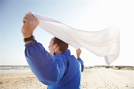 excited for fitness - Sporty man celebrating at beach in sun Stock Photo - Premium Royalty-Free, Code: 6122-07693496