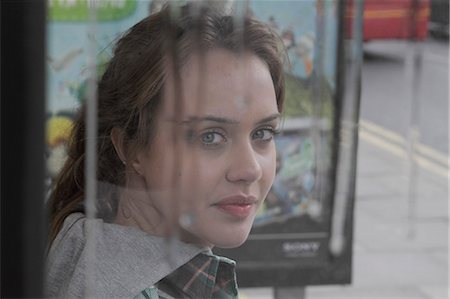 people at the bus stop shelter - Young woman at bus shelter in rain Stock Photo - Premium Royalty-Free, Code: 6122-07693651