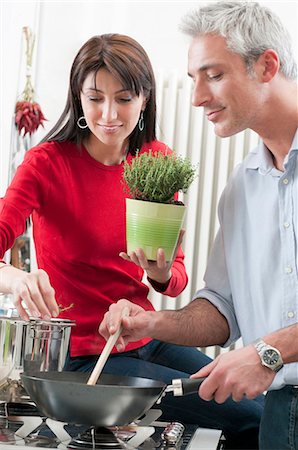 Mid aged couple cooking together Stock Photo - Premium Royalty-Free, Code: 6122-07693673