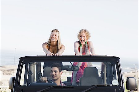 simsearch:649-08543954,k - Women standing in jeep on road trip Photographie de stock - Premium Libres de Droits, Code: 6122-07694060