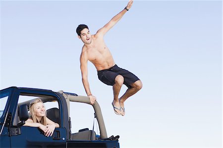 simsearch:6113-07147043,k - Man jumping out of jeep Stock Photo - Premium Royalty-Free, Code: 6122-07694064