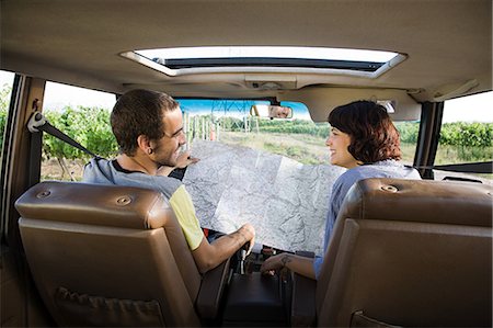Young couple in vehicle with map Stock Photo - Premium Royalty-Free, Code: 6122-07694086