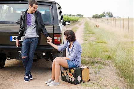 sitting suitcase - Couple holding hands by suv Stock Photo - Premium Royalty-Free, Code: 6122-07694092