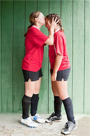 Girl soccer player kissing teammate Photographie de stock - Premium Libres de Droits, Code: 6122-07695297