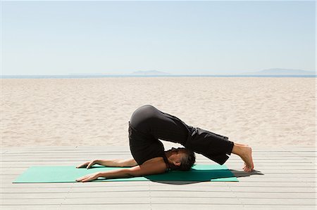 fit woman looking out - Senior woman doing yoga on beach Stock Photo - Premium Royalty-Free, Code: 6122-07695678