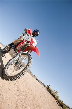 Man riding dirt bike on dirt track Stock Photo - Premium Royalty-Free, Code: 6122-07695766