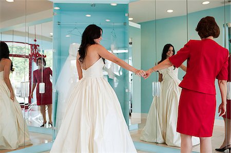 simsearch:614-03763841,k - Daughter trying on wedding dress, holding hands Stock Photo - Premium Royalty-Free, Code: 6122-07695827