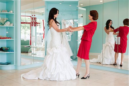 simsearch:614-03763841,k - Daughter trying on wedding dress, holding hands Stock Photo - Premium Royalty-Free, Code: 6122-07695831