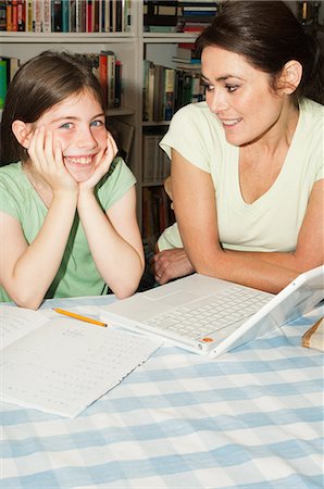 simsearch:649-07064282,k - Mother helping daughter with homework Photographie de stock - Premium Libres de Droits, Code: 6122-07696735