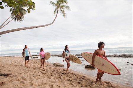 palm trees in rows - Four young friends carrying surfboards on beach Stock Photo - Premium Royalty-Free, Code: 6122-07696940