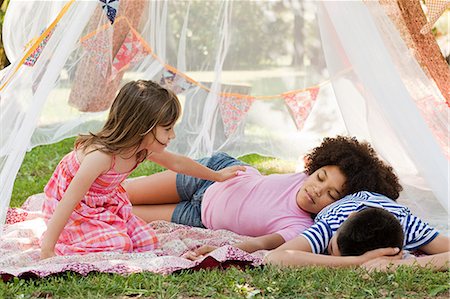 sleeping backyard - Three friends sleeping in summer netting tent Stock Photo - Premium Royalty-Free, Code: 6122-07697154